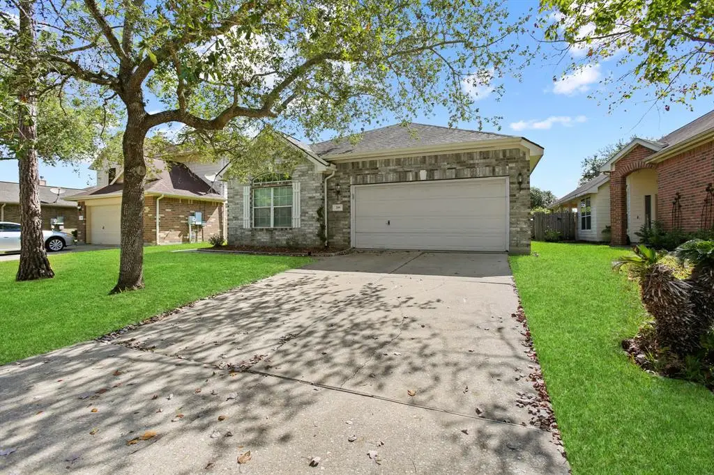 Dickinson real estate — Boatman Realty Dickinson Texas suburban home with tree-lined yard and green lawn